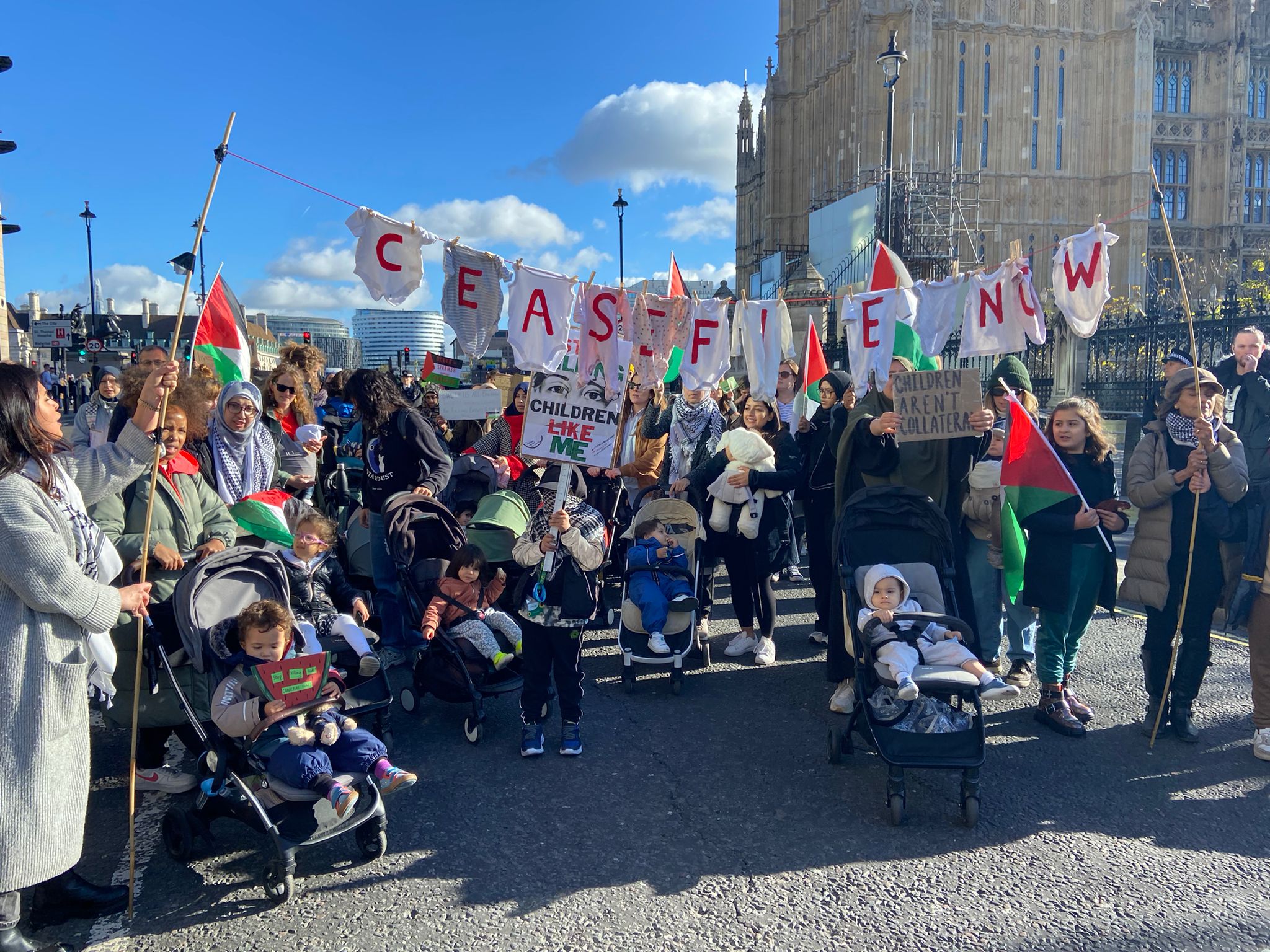 Mothers and children gather outside the UK parliament to demand a ceasefire.